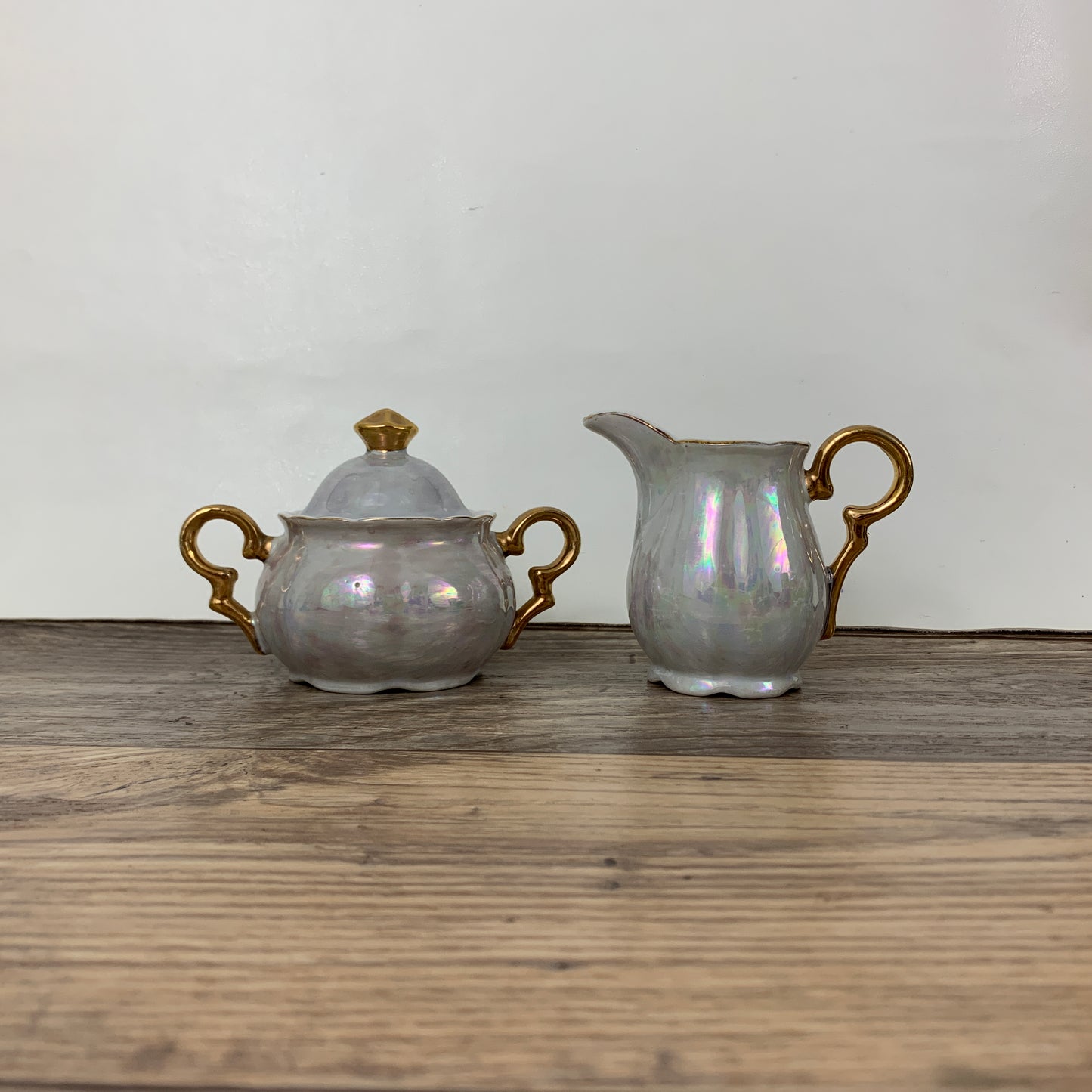 Lidded sugar bowl and cream pitcher with an iridescent glaze