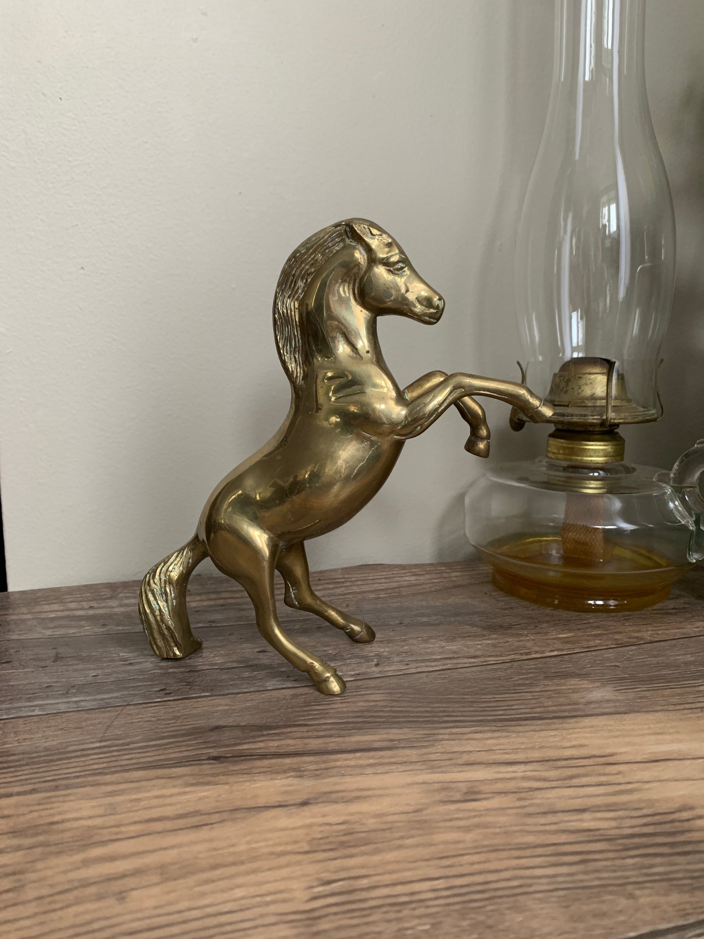 A brass horse rearing on its hind legs