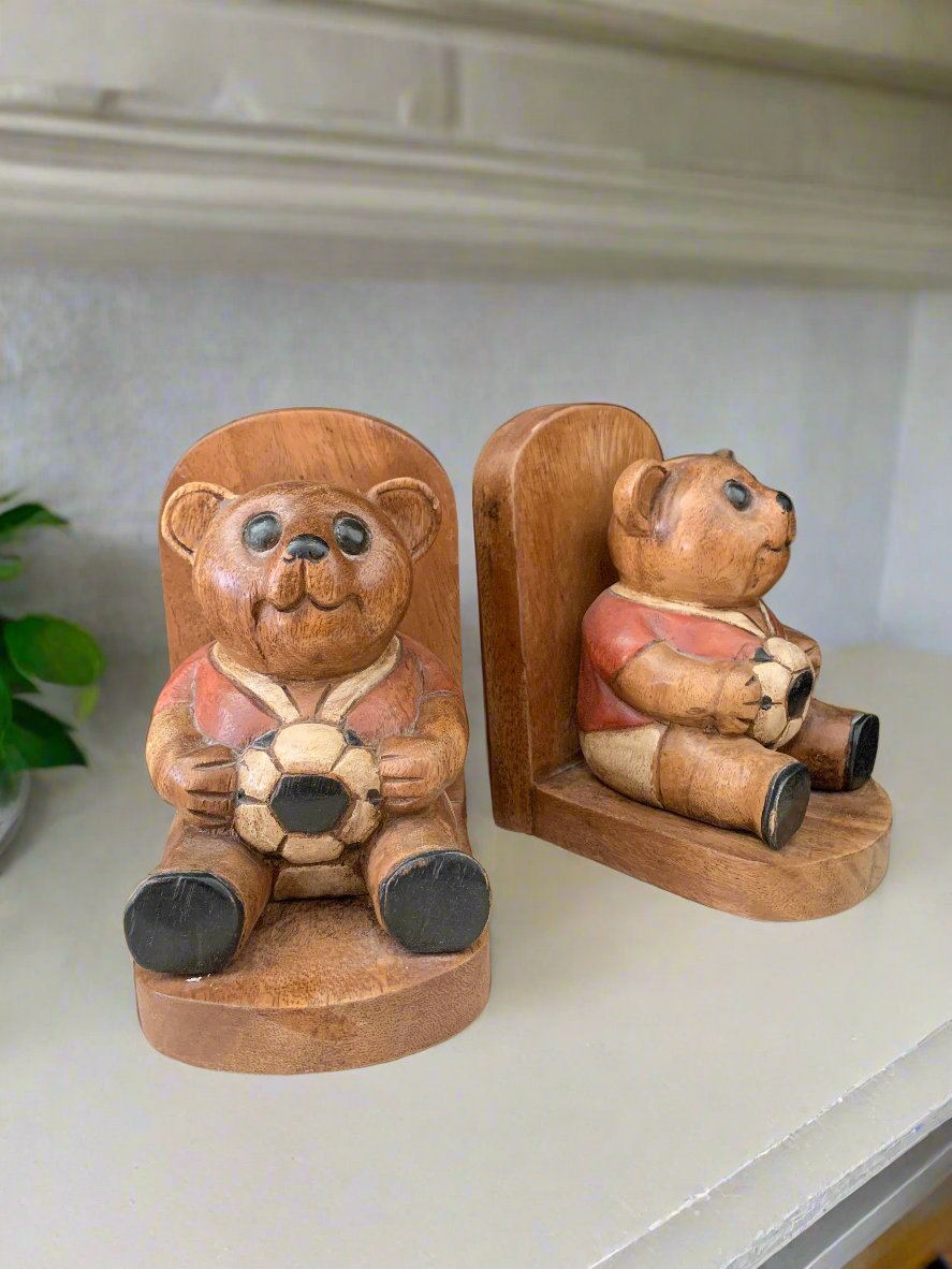 Two wooden bookends with bears holding soccer balls