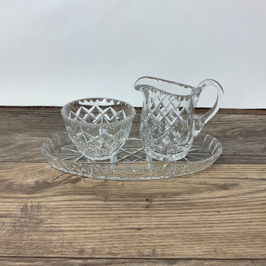 A crystal cream and sugar set on a try with a cut pattern