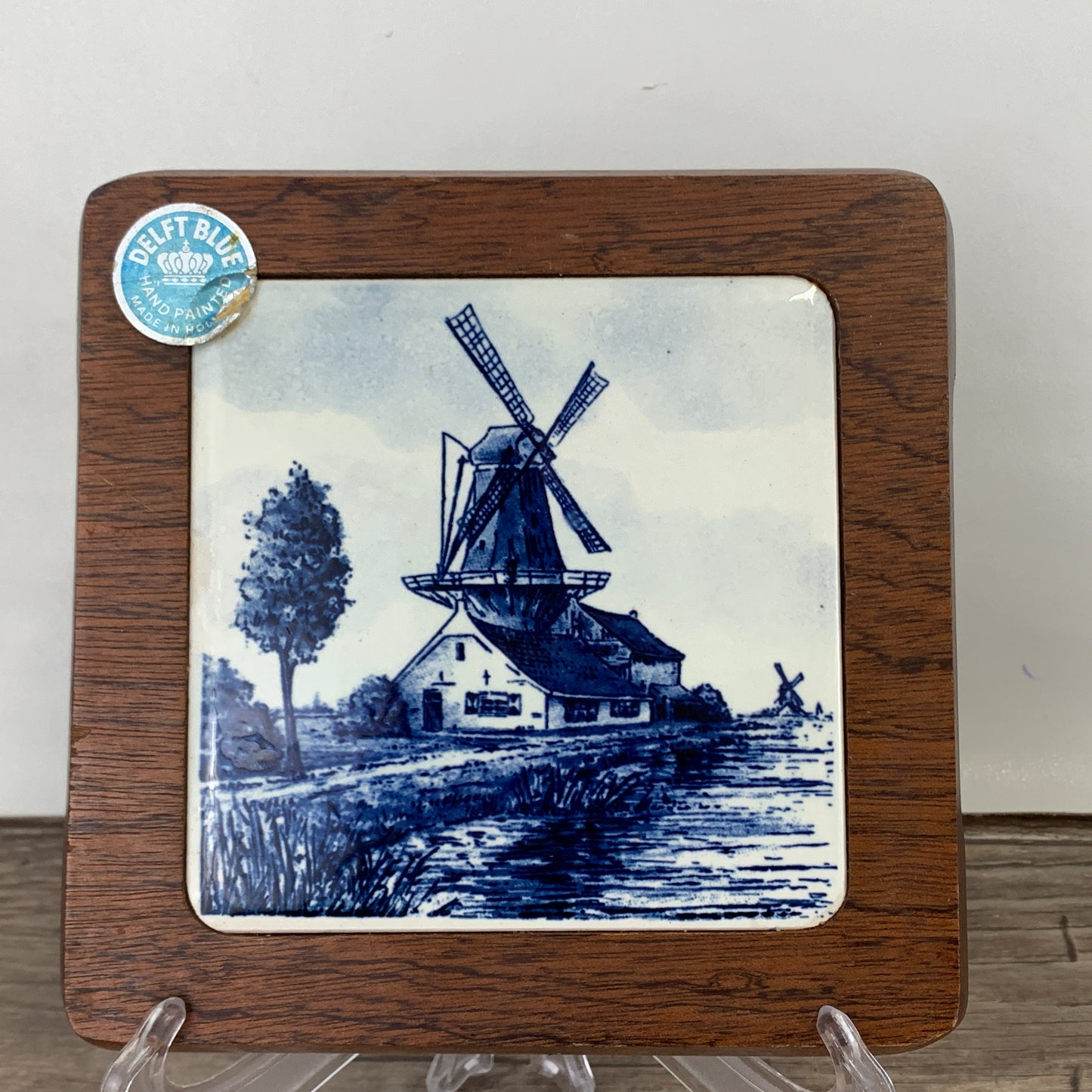 A blue and white landscape scene with a windmill