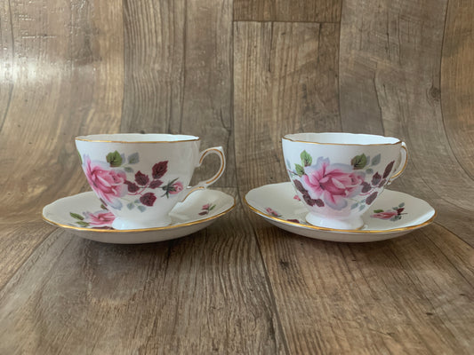 Two white teacups with pink roses