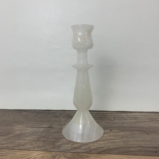 A carved white stone candlestick holder